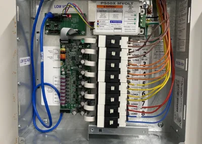 An open electrical panel with wiring and circuit breakers.